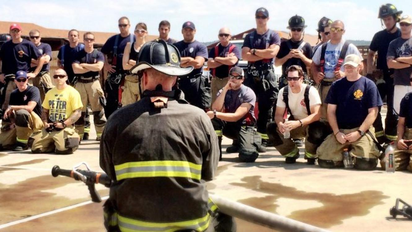 fire instructor in front of firefighters stock