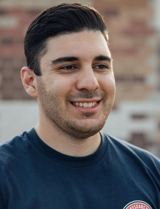 man with dark hair smiling