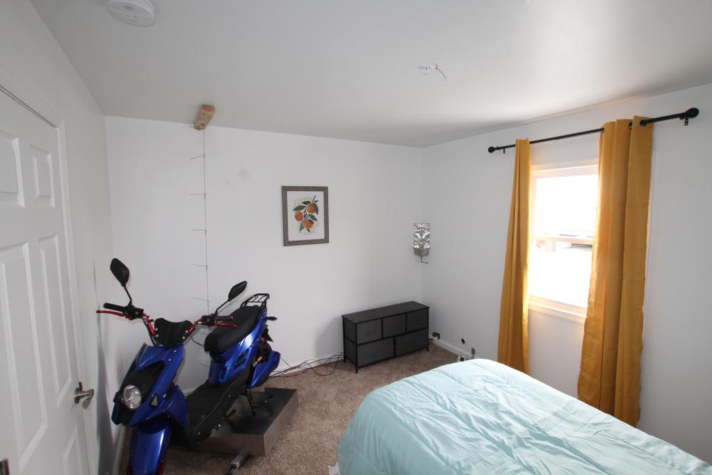 Pre-experiment photo shows e-scooter positioned in closed bedroom