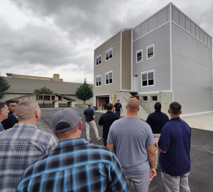 FSRI researcher Keith Stakes briefs technical panel members on the design and construction of the two multi-story structures