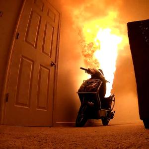 Examining the Fire Safety Hazards on E-Scooter and the Image shows the E-scooter on fire in a living room